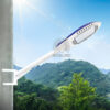 Đèn cao áp LED ANITA lắp trên cần vươn từ cột, nền trời nắng và đồi xanh